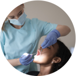 Dental hygienist examines patient's teeth