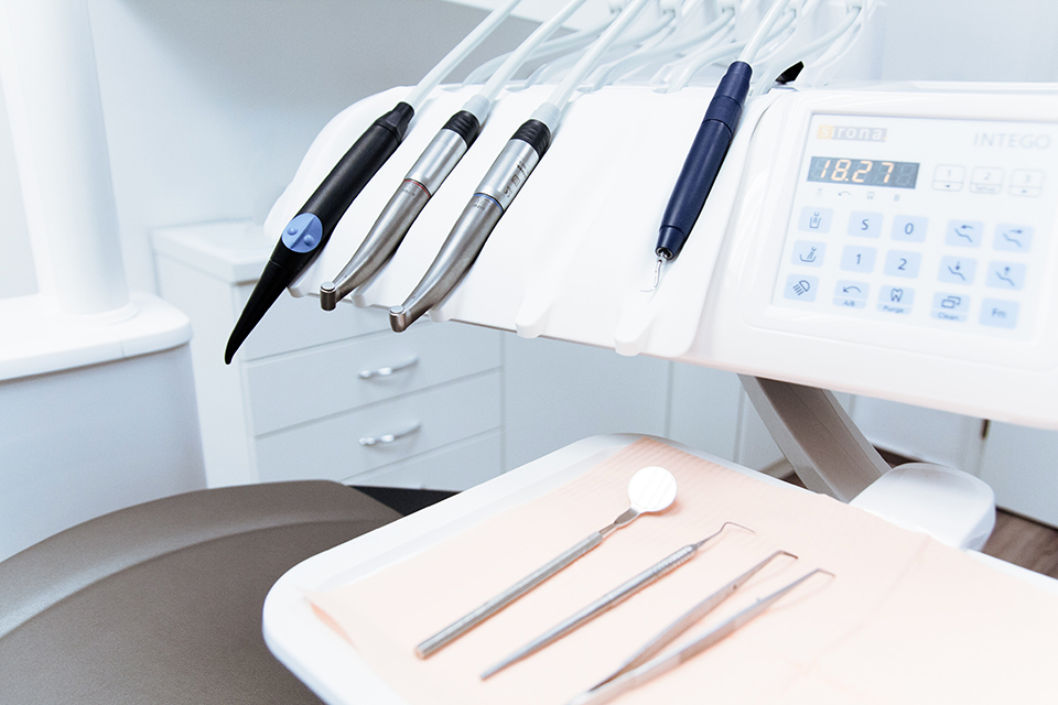 Photo of dental chair with hygiene tools