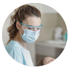 Image of dental expert in mask and safety glasses